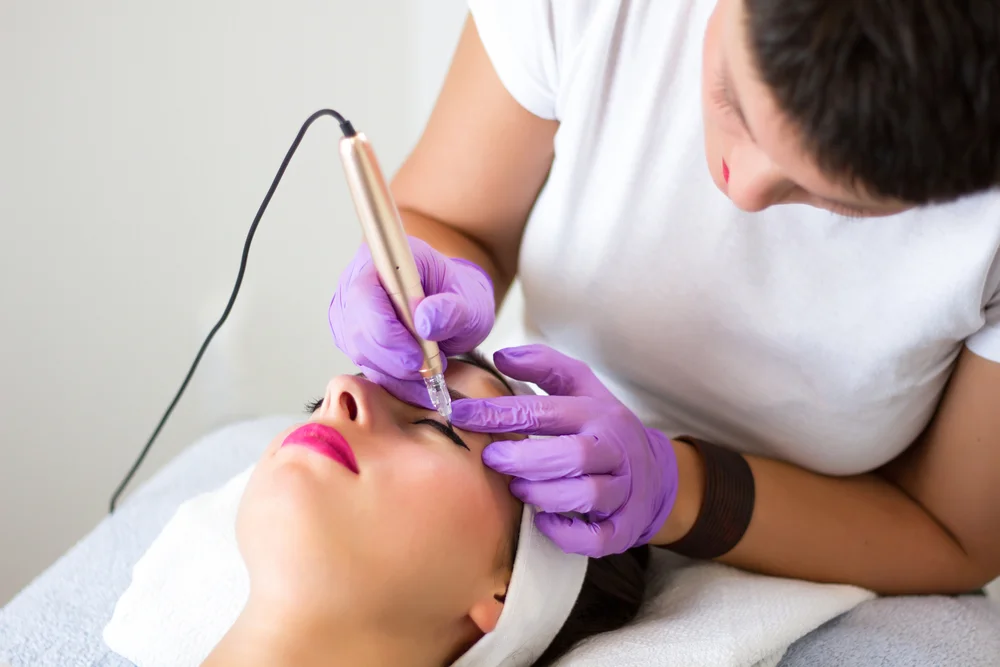 Permanent Eyeliner - The Ultimate Guide To A Beautiful, Effortless Look 3 Professional esthetician applying permanent eyelid makeup tattooing in a beauty studio / What Is Permanent Eyeliner? / Why Should You Consider Permanent Eyeliner? / The Permanent Eyeliner Procedure: What to Expect / Benefits of Permanent Eyeliner / Long-Lasting Results / Enhance Your Natural Beauty / How to Choose the Right Technician for Permanent Eyeliner / FAQs About Permanent Eyeliner / Ciao Bella Salon and Spa in Islamorada Florida