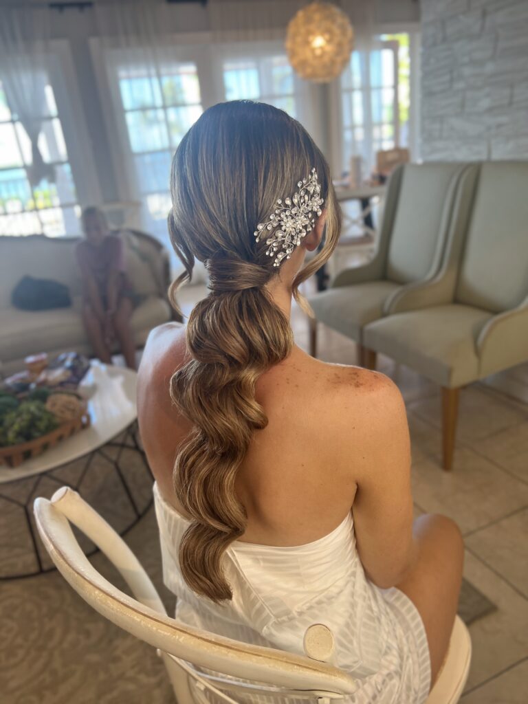 Sleek Ponytail with a Twist  Beach Wedding Hair & Makeup Styles in Islamorada / Your Guide to Picture-Perfect Looks in the Florida Keys / Why Beach Wedding Beauty Needs a Different Approach / Hair Styles That Shine on the Shore / Makeup Styles That Last and Glow / Getting Ready in Paradise with Ciao Bella / Why Brides Choose Islamorada / Don’t Forget These Wedding Hair & Makeup Tips / Ciao Bella Salon and Spa in Islamorada