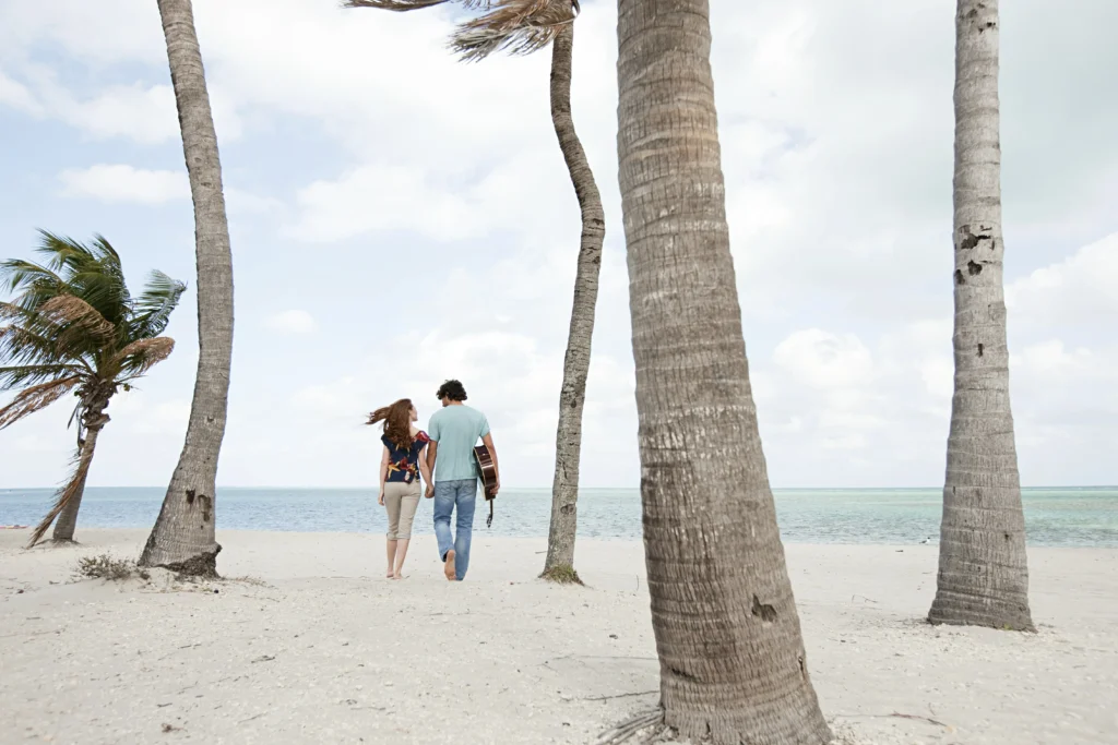 Honeymoon in the Florida Keys: The Ultimate Relaxation Experience for Newlyweds 1 Young couple walking on beach - Honeymoon in the Florida Keys: The Ultimate Relaxation Experience for Newlyweds - Ciao Bella Salon Spa Islamorada Florida Keys