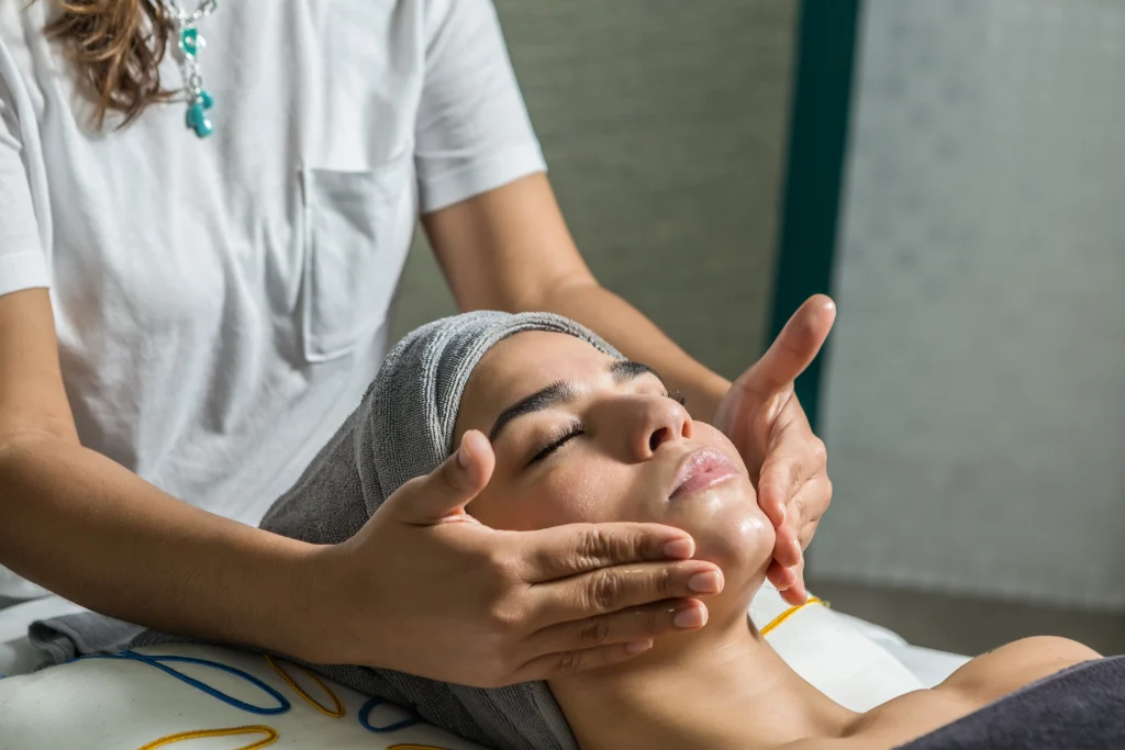Award-Winning Spa Treatments in Islamorada: Relax & Rejuvenate at Ciao Bella 1 Woman enjoying facial massage in center - Award-Winning Spa Treatments in Islamorada: Relax & Rejuvenate at Ciao Bella