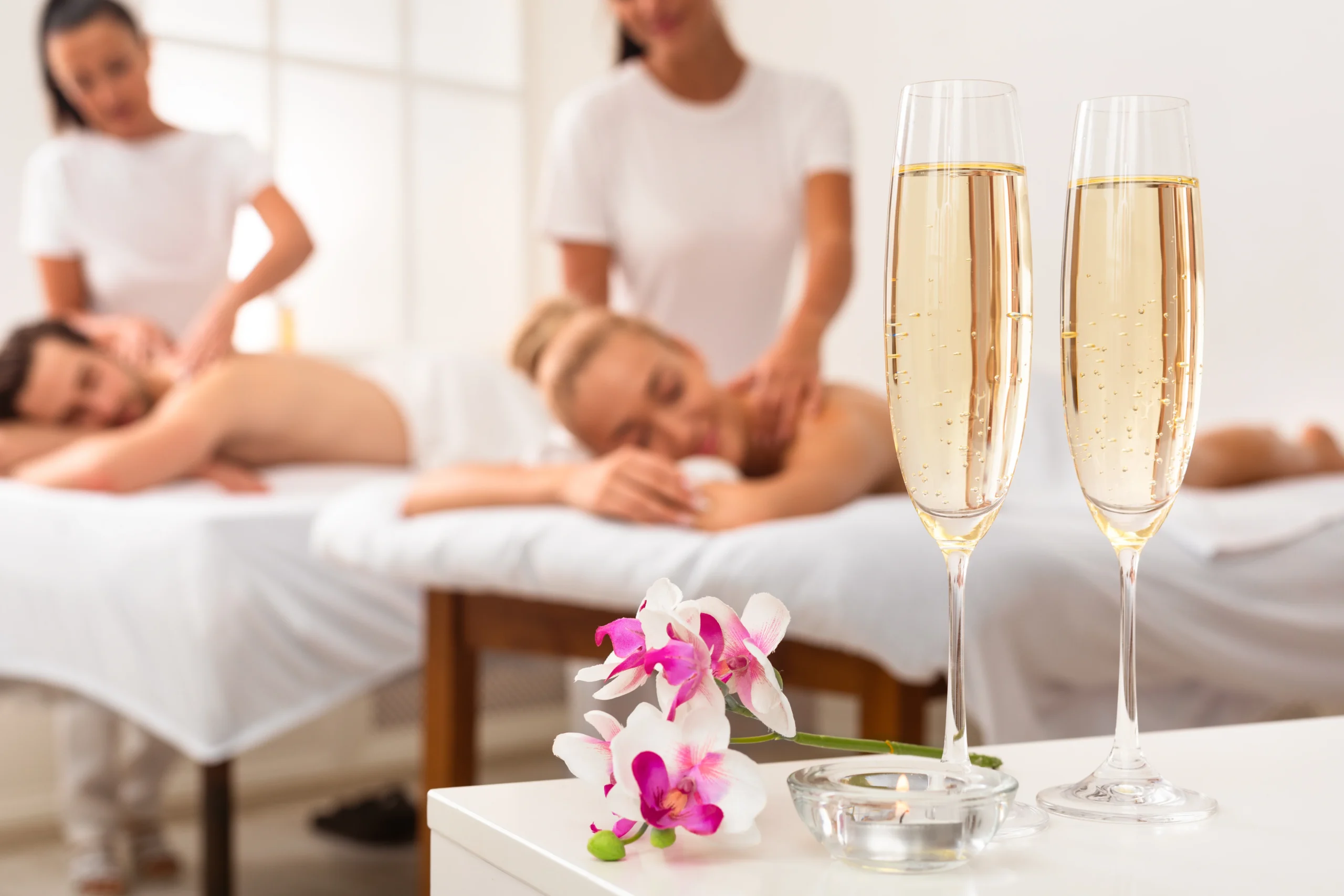 Couple Enjoying Massage, Spa Composition With Champagne Flutes And Flowers - Couples’ Stay-cation in Islamorada: End the Year Together with a Spa Day at Ciao Bella
