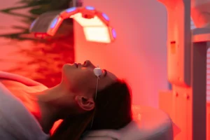 The Future of Wellness: How Biohacking at Ciao Bella Supports Longevity and Full Body Healing - closeup female patient undergoes red led light rlt therapy skin rejuvenation modern - Ciao Bella Salon Spa