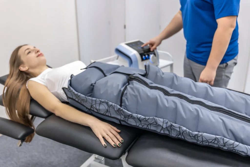 Women receives leg compression therapy in clinic - Deep Recovery: When to Use Compression Boots and Their Real Benefits - Ciao Bella Spa Islamorada - Wellness Center