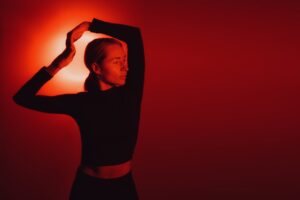 woman posing with arms overhead in red light therapy - Pre-Summer Biohacking Detox in Islamorada