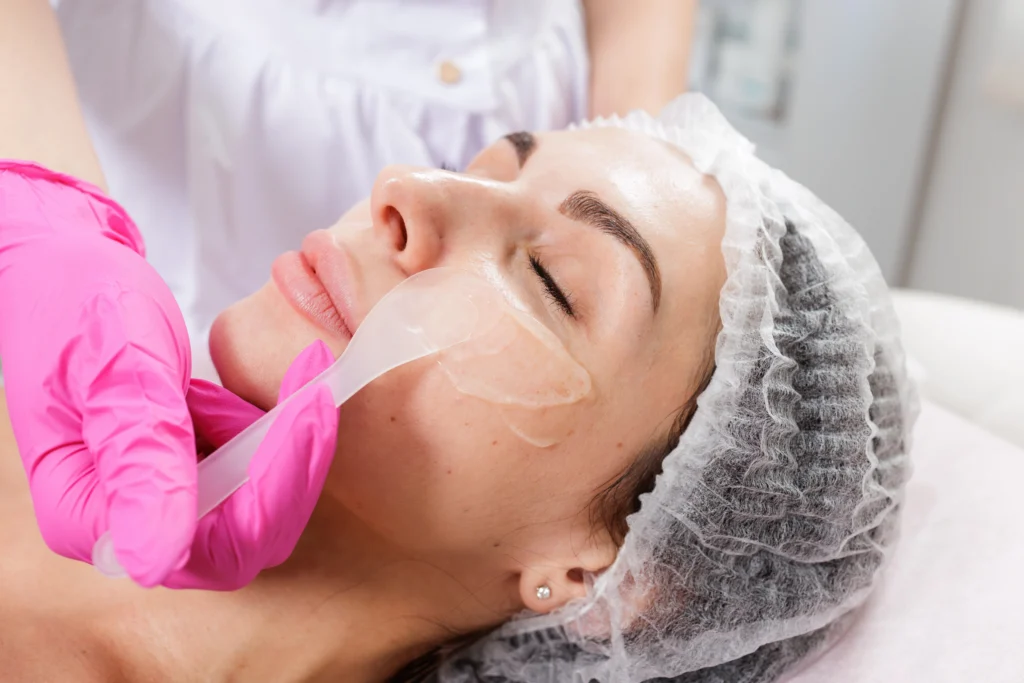 The Science of Rejuvenation: Microneedling vs. Chemical Peels 2 woman receiving facial treatment in beauty -The Science of Rejuvenation: Microneedling vs. Chemical Peels