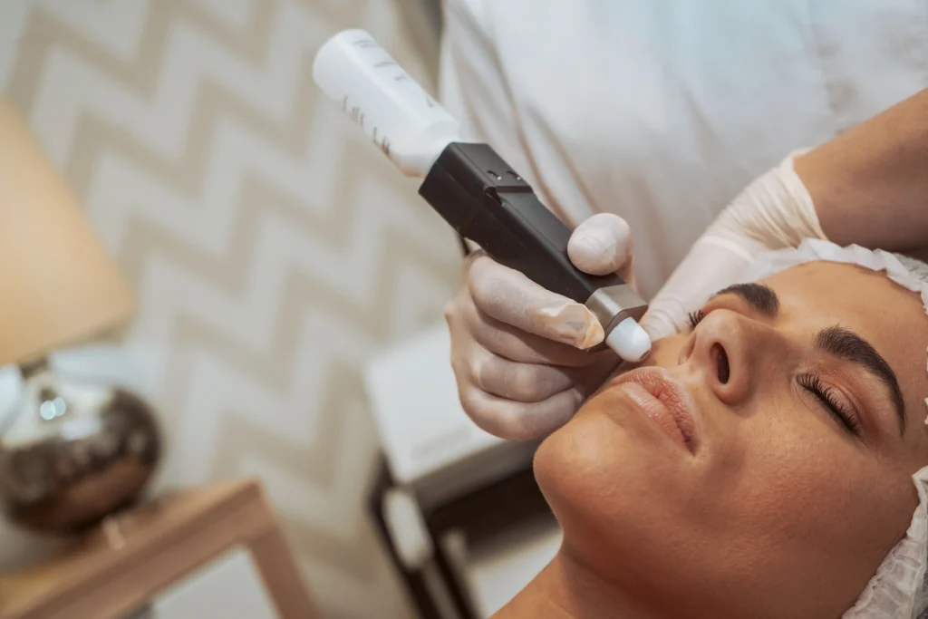 The Science of Rejuvenation: Microneedling vs. Chemical Peels 1 woman receiving facial treatment in spa - The Science of Rejuvenation: Microneedling vs. Chemical Peels