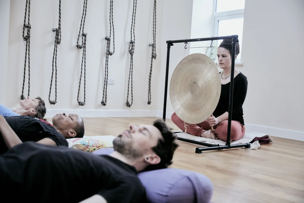 The Science of Sound: How a Sound Healing Session Resets Your Nervous System 1 woman using a gong during a sound therapy session - The Science of Sound: How a Sound Healing Session Resets Your Nervous System - Ciao Bella Islamorada