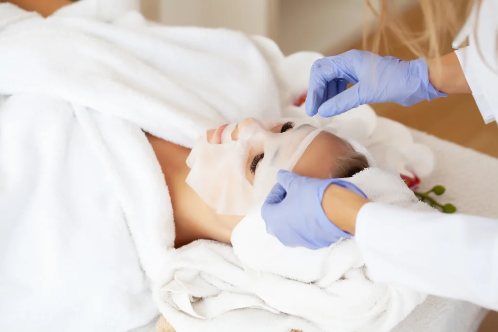 woman receives facial mask treatment at spa - How Can a MedSpa Facial Give You Both Results and Relaxation in Islamorada?