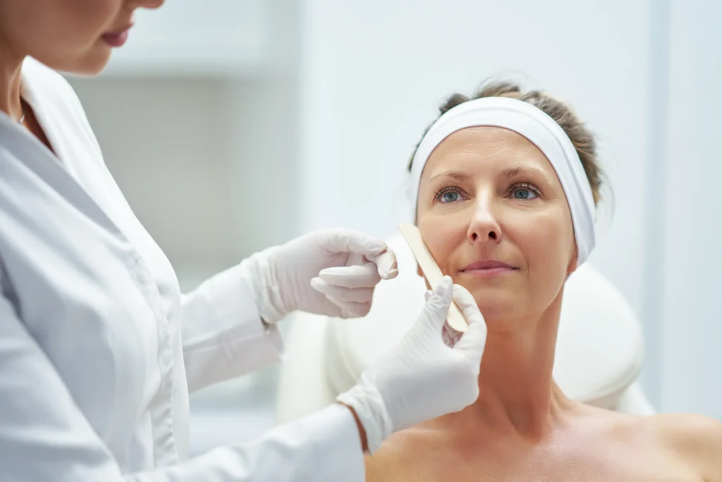woman receiving beauty treatment in bright white