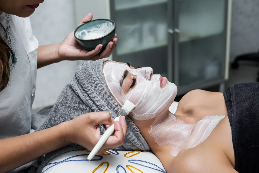 woman receiving facial beauty treatment at spa - How Can a MedSpa Facial Give You Both Results and Relaxation in Islamorada?