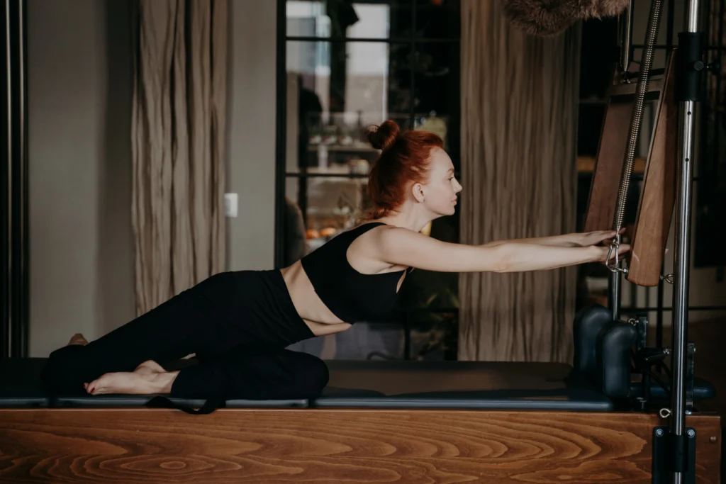 focused woman practicing pilates exercise