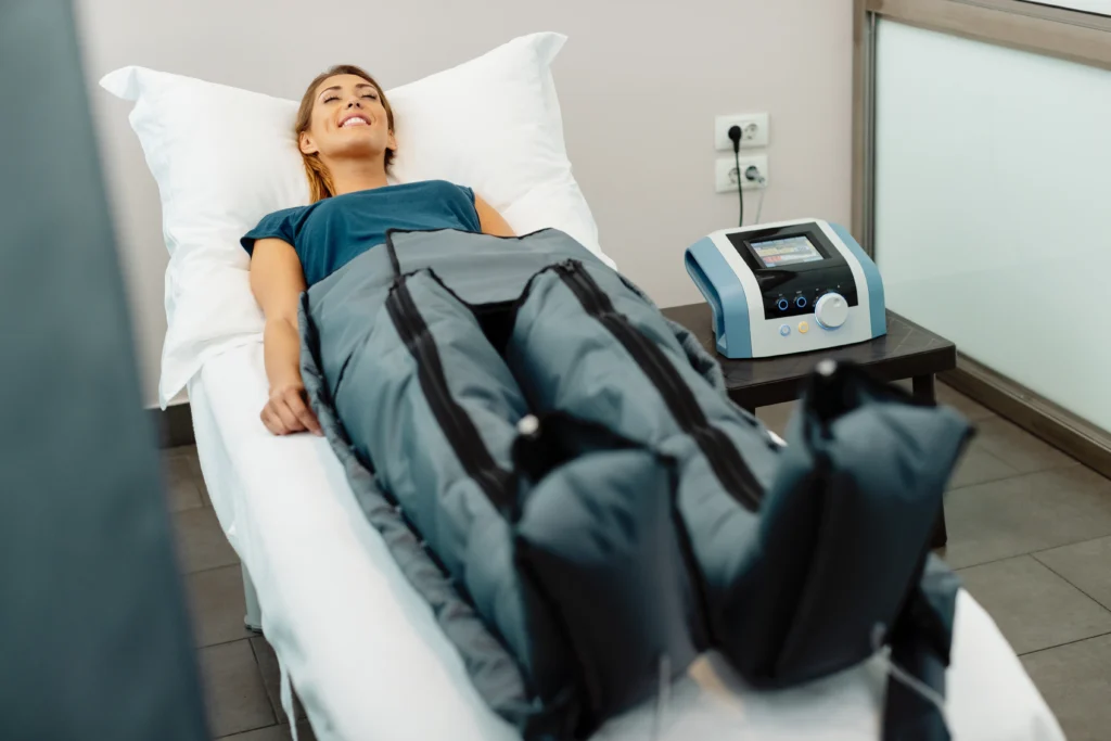 relaxed woman enjoying in pressotherapy treatment - Why Do My Legs Feel Heavy and Swollen in Hot Weather?