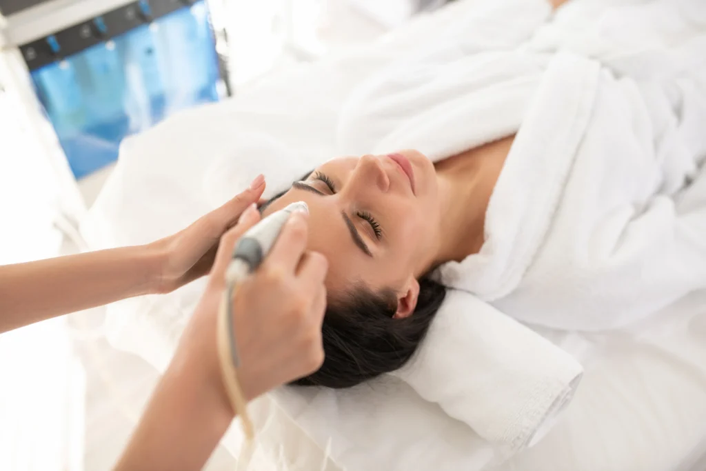 relaxed woman receiving facial skin treatment - What Is the Difference Between XERF and Traditional Radiofrequency Treatments?