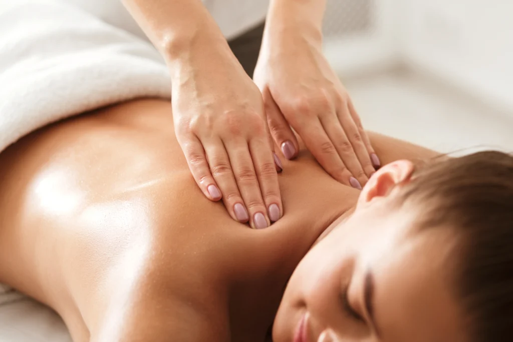 woman enjoying relaxing back massage in spa - How Do You Know Which Massage You Need: Deep Tissue or Swedish?
